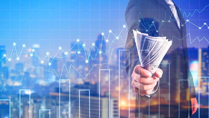 Businessman with money in hand, US dollar (USD) bills - investment, success and profitable business concepts.Forex graph on the business background. A metaphor of international financial consulting